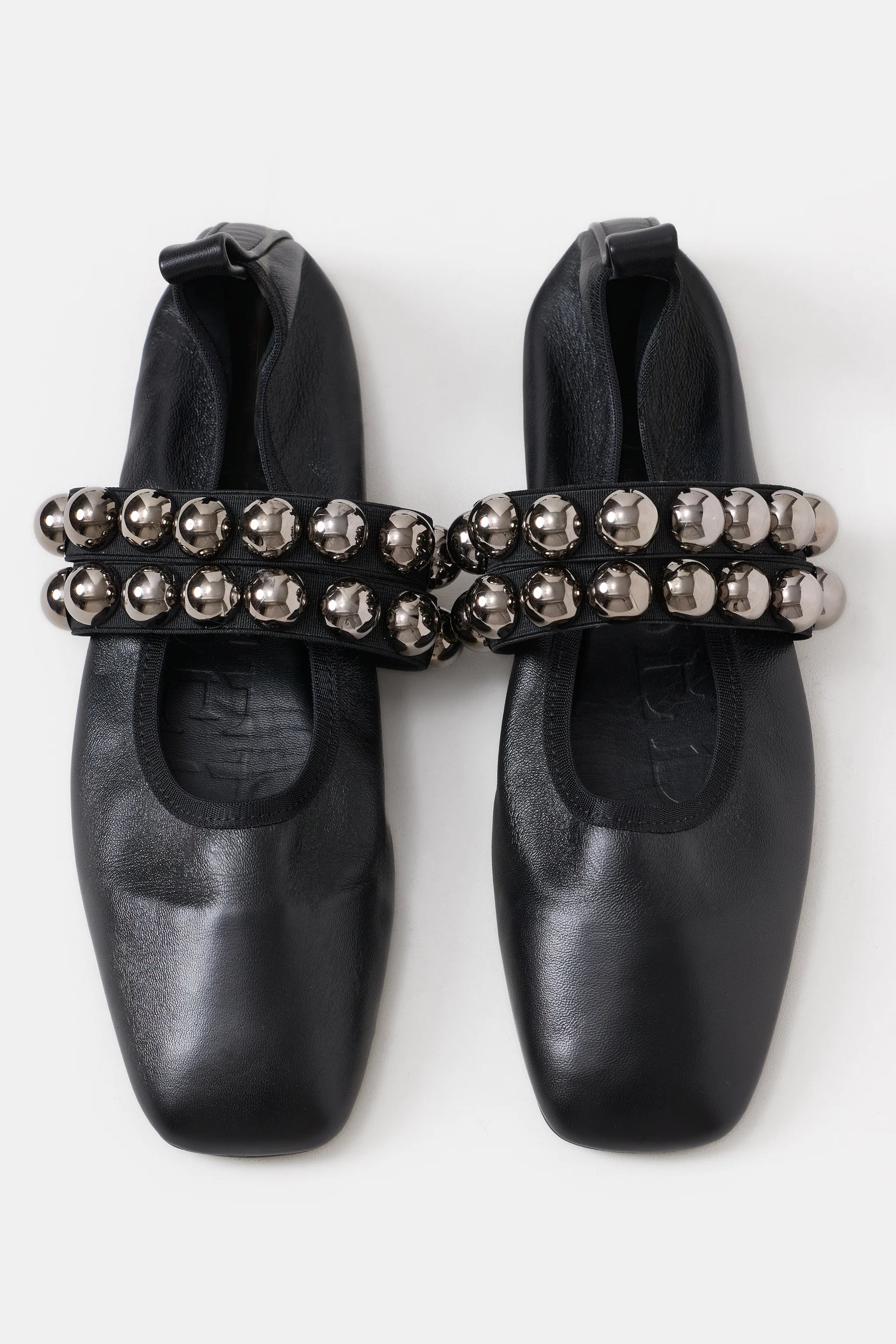 The CLOSED Ballerina is a pair of black, square-toe flats with two thick straps topped by shiny silver beads and a comfy leather insole. Made in Italy.