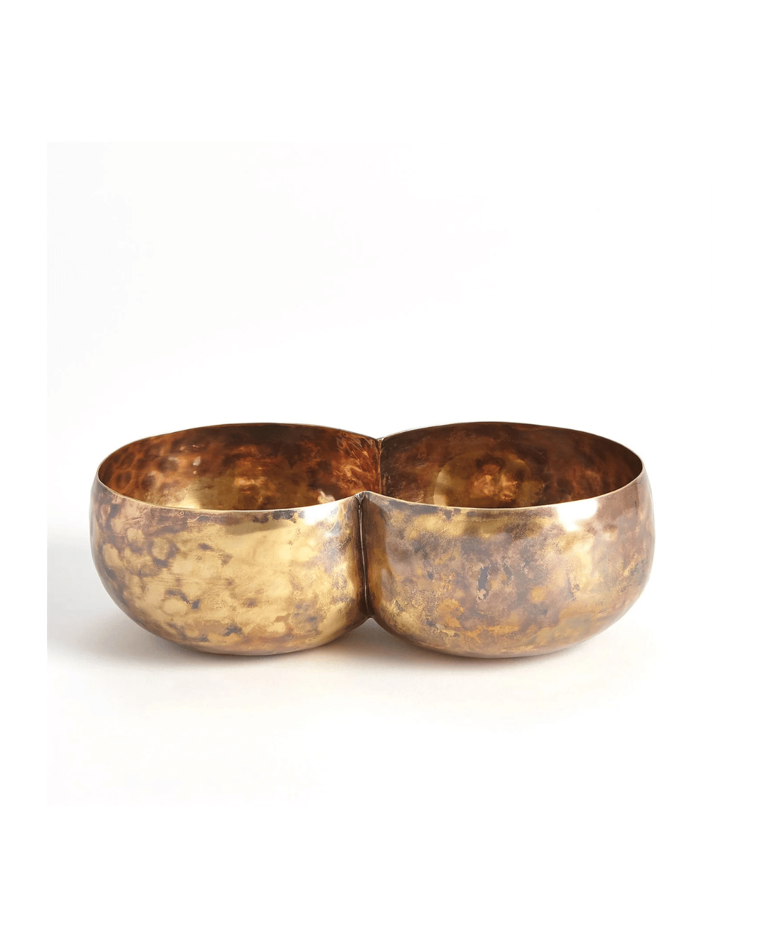 Against a plain white background, the Double Alchemy Container by Global Views features two connected brass bowls with a hammered texture and warm golden hue, creating an eye-catching design.