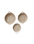 Three round, Grass & Date Leaf Baskets with loop handles, arranged in a triangular formation on a white background in a Scottsdale Arizona bungalow by Creative Co-op.