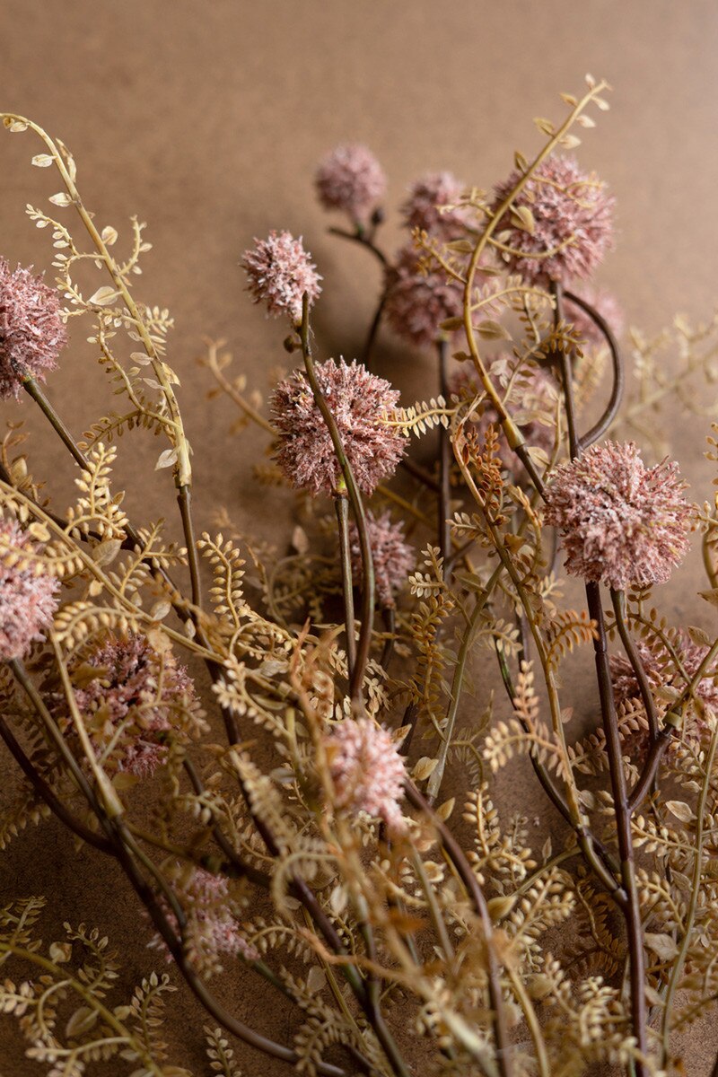 Pink Melaleuca by Kalalou, Inc features dried pink globe flowers, rosy pink melaleuca spray, and fern-like foliage set against a brown background for a rustic, natural look—ideal for spring floral arrangements.