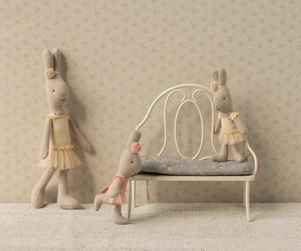 Maileg fabric bunny dolls with pastel outfits, styled in a cozy, softly colored nursery scene with vintage accents.