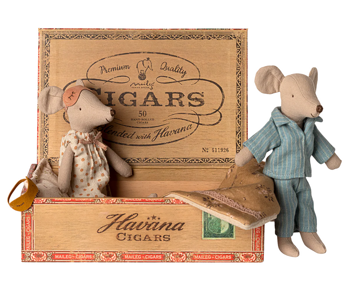 Maileg Mum &amp; Dad Mice in a cigar box bed by Maileg, with Mum in a dress and Dad in striped pajamas, cozy under a blanket.