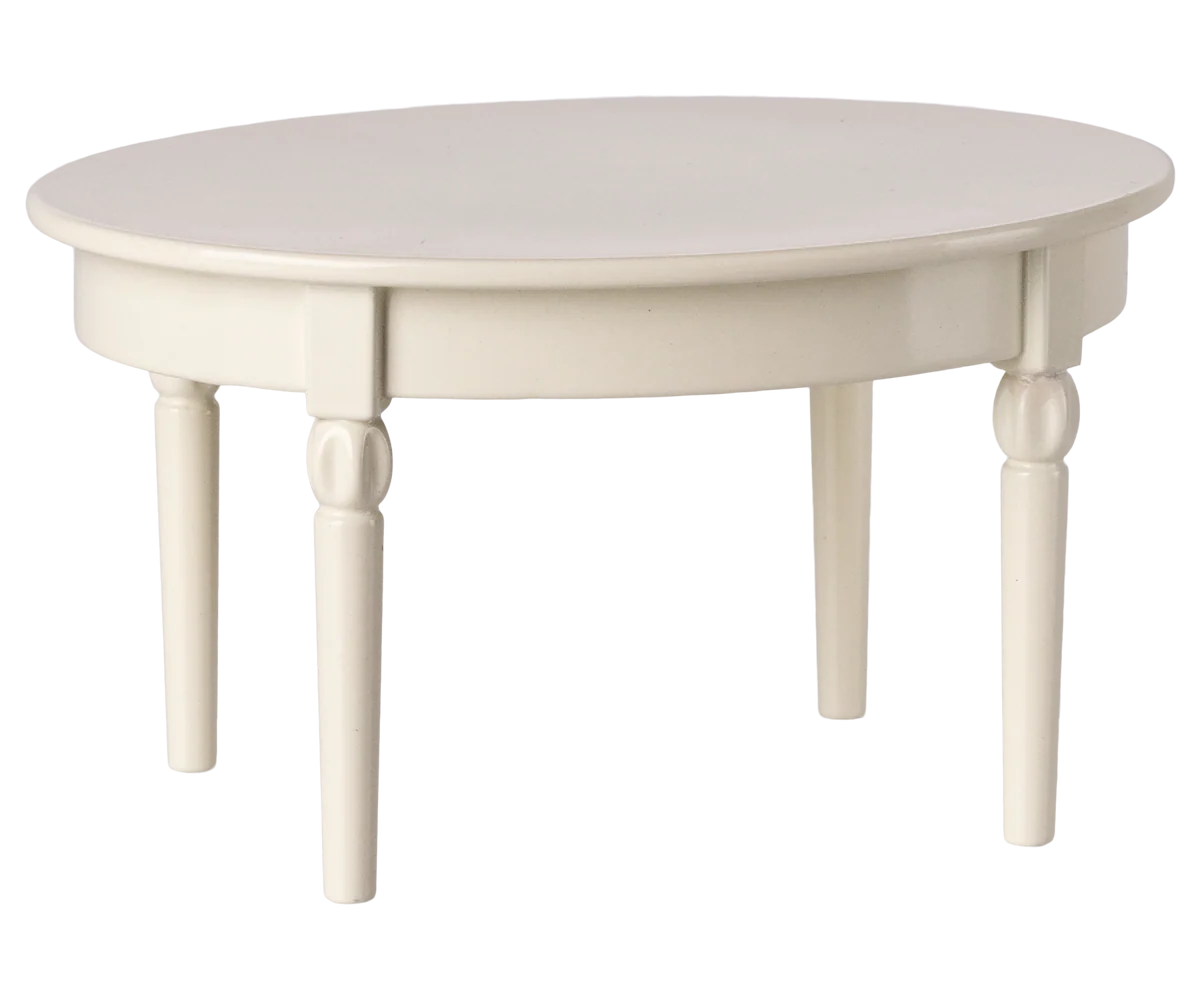The Maileg Furniture round white wooden table by Maileg features four turned legs, making it ideal for dollhouses or a Maileg Mouse setup. Shown against a plain white background.
