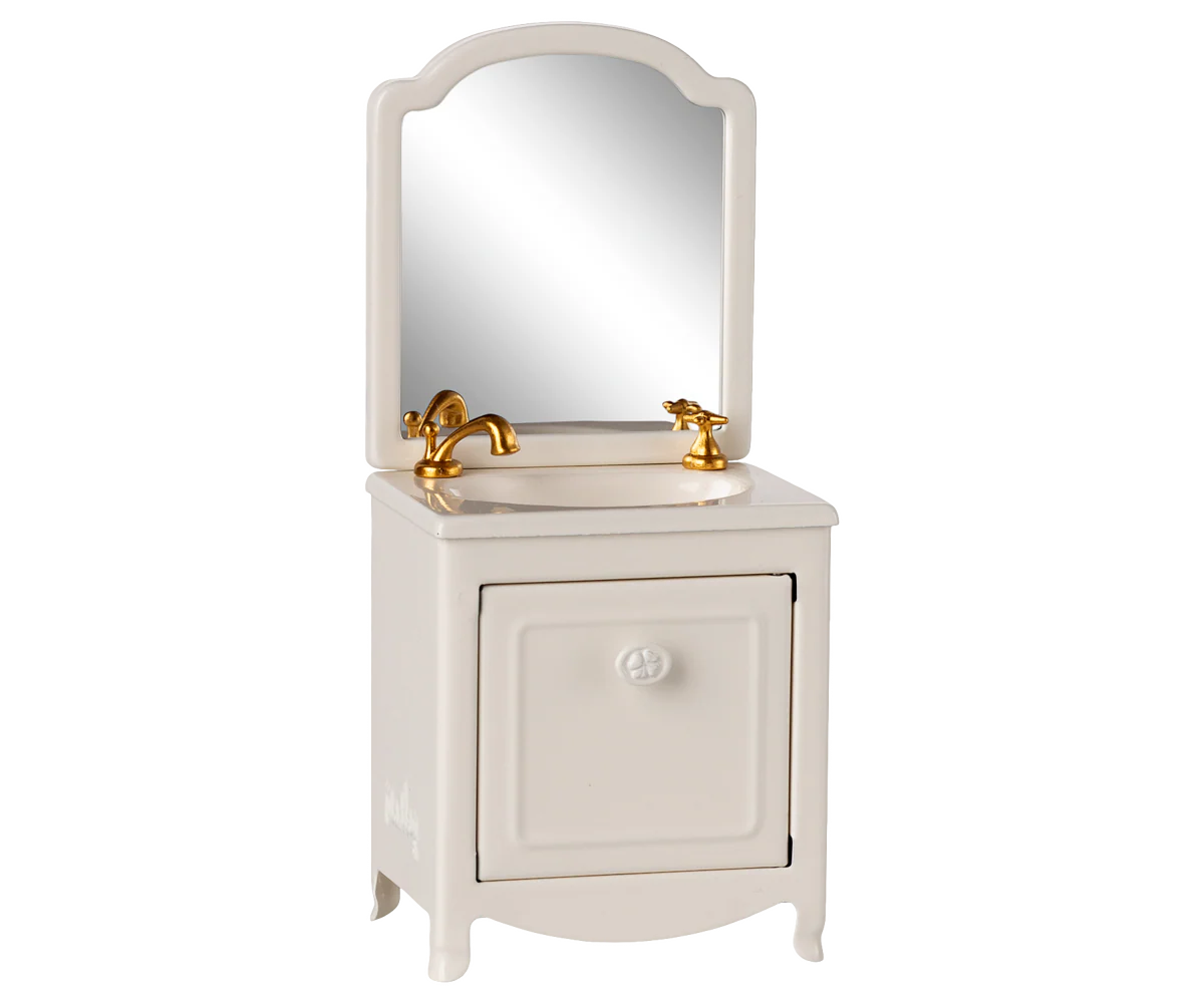 The Maileg Sink Dresser by Maileg features a white cabinet, gold faucet, and arched mirror—ideal for bringing Mouse Hole Farmhouse charm to whimsical dollhouse bathroom scenes.