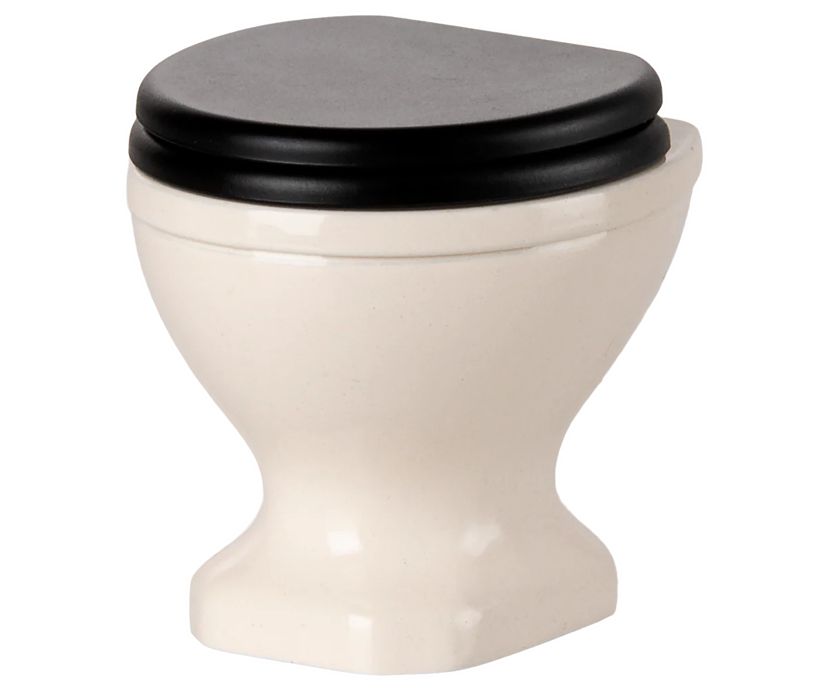 The Maileg Water Closet by Maileg is a small, white ceramic toilet with a closed black lid, set against a plain white background—an ideal modern accent for your SuitCasa bathroom.