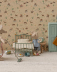 Two toy mice in a miniature room: one vacuums while the other stands by a Maileg Vintage Single Bed. Scattered toys, a green wardrobe, lamp, and western animal-and-cacti wallpaper complete the charming Maileg scene.