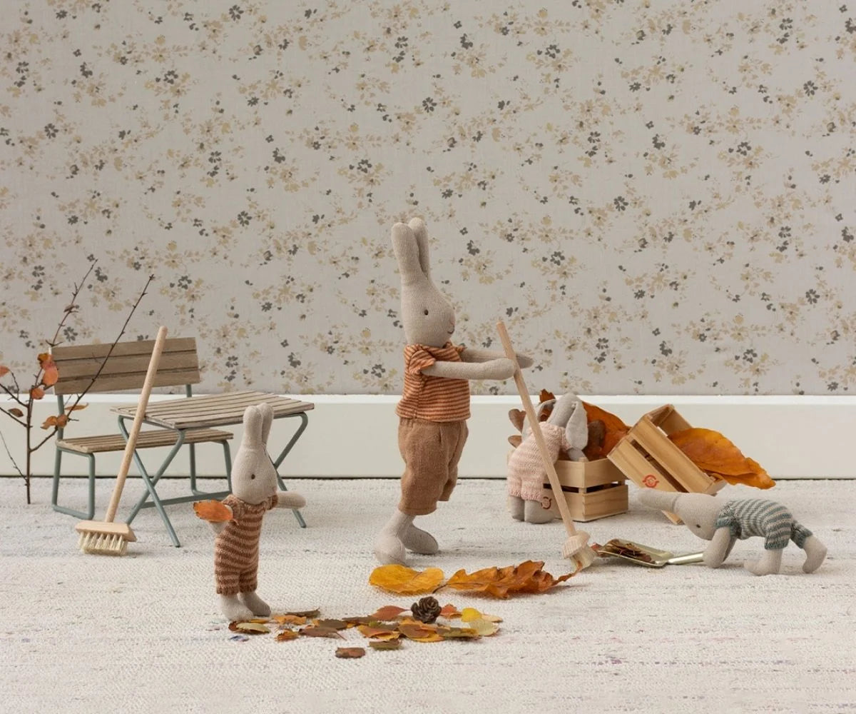 Maileg Broom Set with bunnies in cozy autumn outfits sweeping leaves, styled by Bungalow Furniture &amp; Accessories.