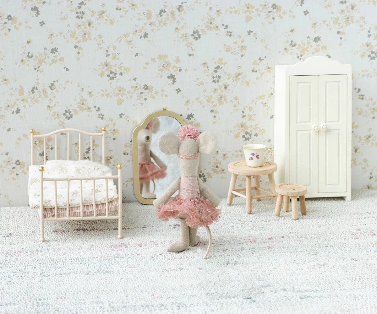 A Maileg toy mouse in a pink tutu stands before the Maileg Mirror in a miniature bedroom with a bed, wardrobe, stool, table, and floral wallpaper.
