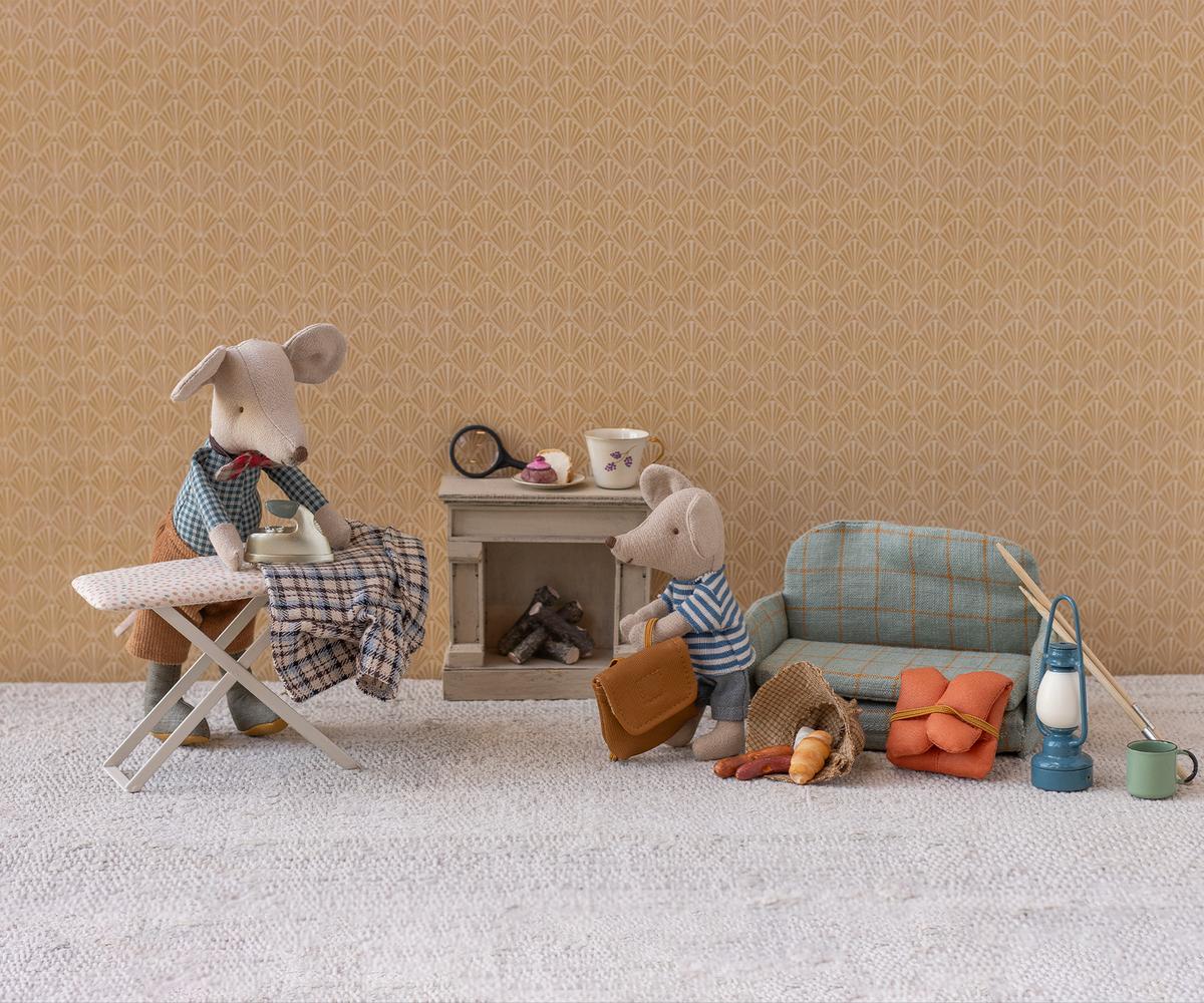Maileg Granddad Mouse by Maileg features two fabric mice in a miniature living room, with magnetic paws for ironing and suitcase-holding. Includes sofa, fireplace, tea set, lantern, basket, food items, and more tiny accessories.