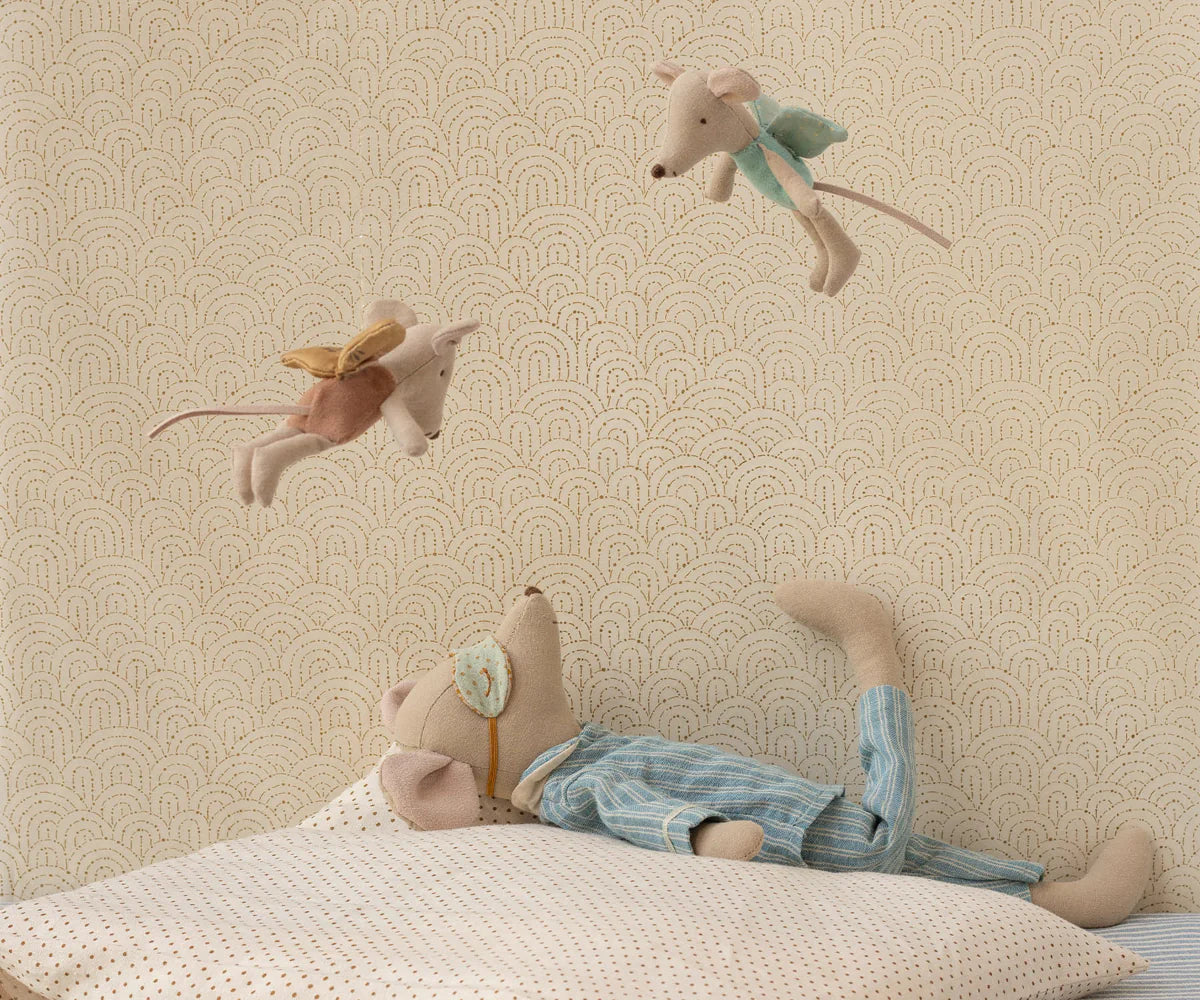 The Maileg Medium Mouse, Pyjamas by Maileg rests on a pillow, looking up at two fairy mice, creating a charming bedtime scene perfect for any child's room.