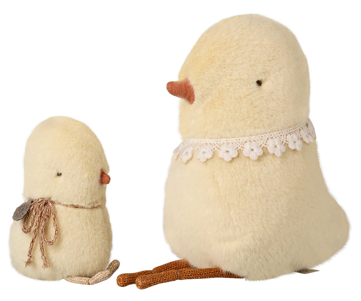 The Maileg Chicken Plush, Small is an adorable yellow plush bird with a brown yarn bow and orange beak. With a soft feel, it sits alongside a larger matching bird on a white background.