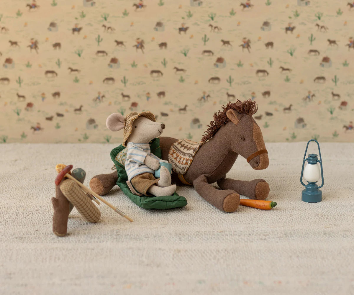 Maileg Pony Small with mouse in a hat, lantern, carrot, and fishing gear on a beige mat; playful nursery decor.