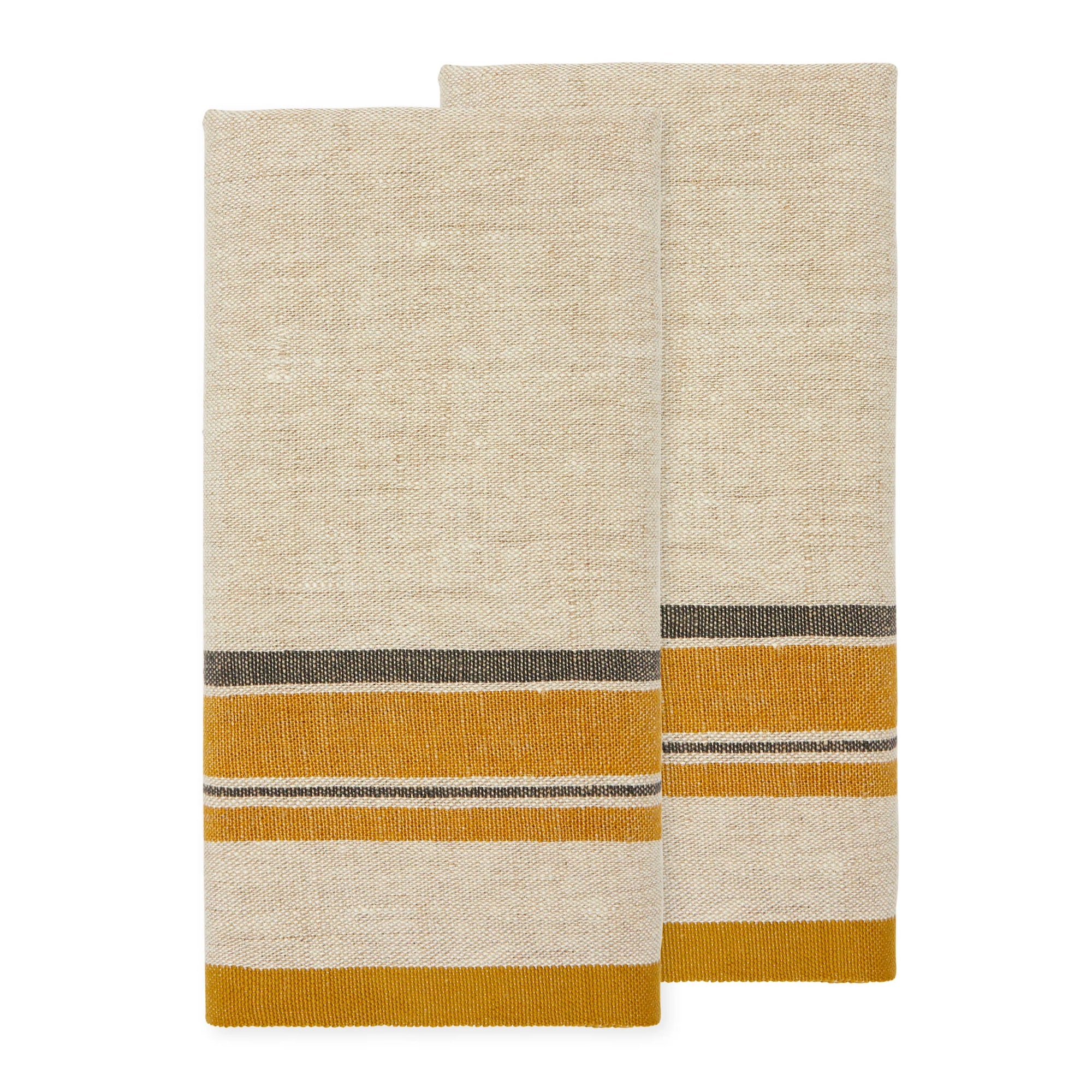Two folded Antibes Natural Towels Set-2 by Caravan, made of beige linen cotton with horizontal mustard yellow and dark gray stripes near one edge, are placed side by side on a white background.