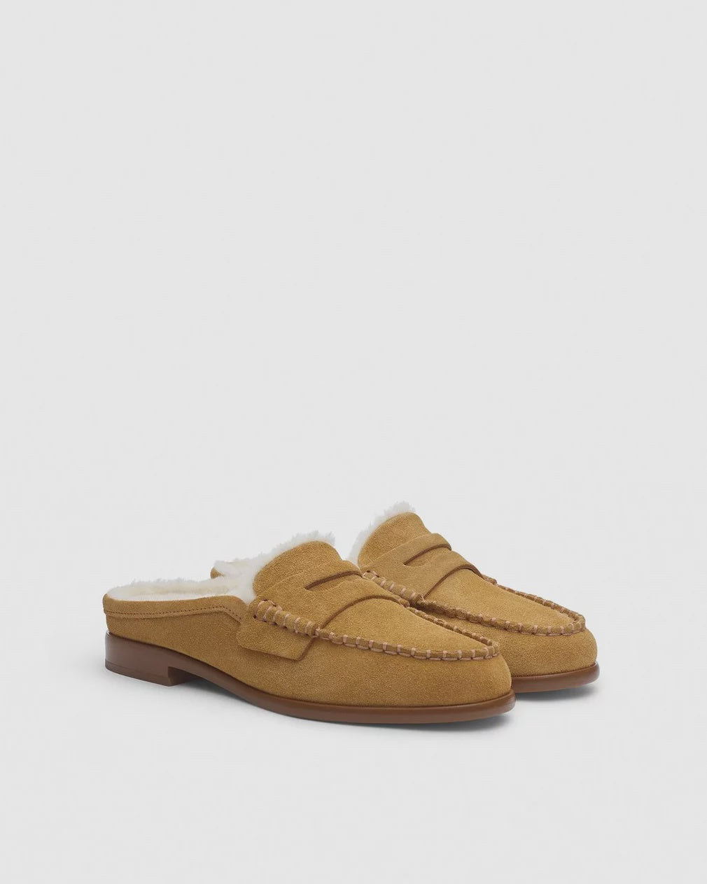 The Carter Mule by Rag &amp; Bone: tan Italian-milled suede mule shoes with white shearling lining and brown stitching, shown against a plain light background.