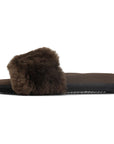 The Roam Cloud Shearling Slider is a brown sandal with a thick plush strap, black sole, and memory foam footbed, shown in profile on a white background.