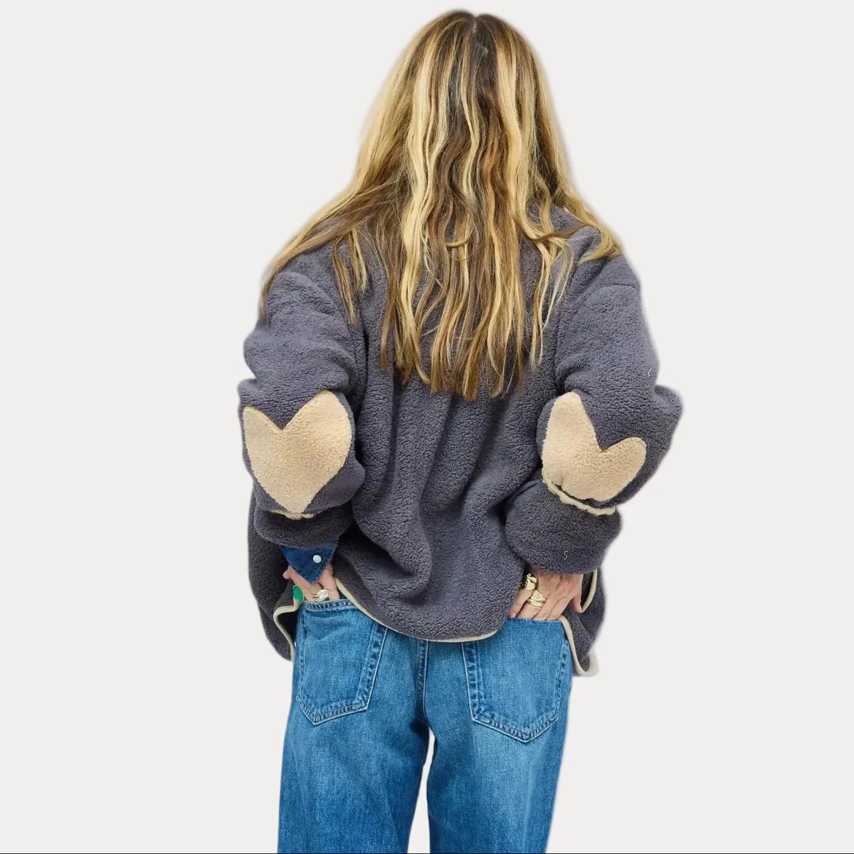 Kerri Rosenthal Coze Magoze jacket with tan heart elbows, styled with blue jeans, back view.
