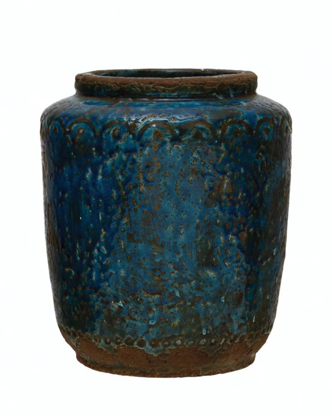 The TerraCotta vase by Creative Co-op features a rustic, blue glazed ceramic design with a cylindrical shape and a round, open top. Its surface has an intriguing textured pattern with darker and lighter hues that lend it a weathered, antique look. Reminiscent of debossed stoneware, the base is left unglazed to showcase natural earthen tones.