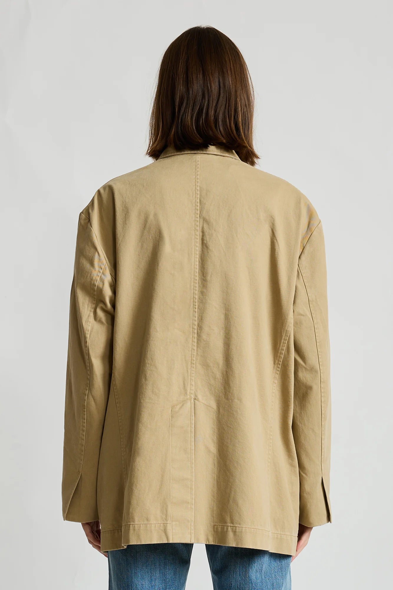 Denimist deconstructed blazer with belt in brown, modeled from the back, casual contemporary womenswear.