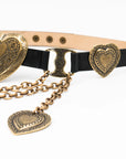 The Brass XL Heart Belt by Streets Ahead Inc is a black leather belt with ornate Italian brass heart-shaped buckles and decorative chains, featuring detailed etchings, handcrafted in Los Angeles and shown on a white background.