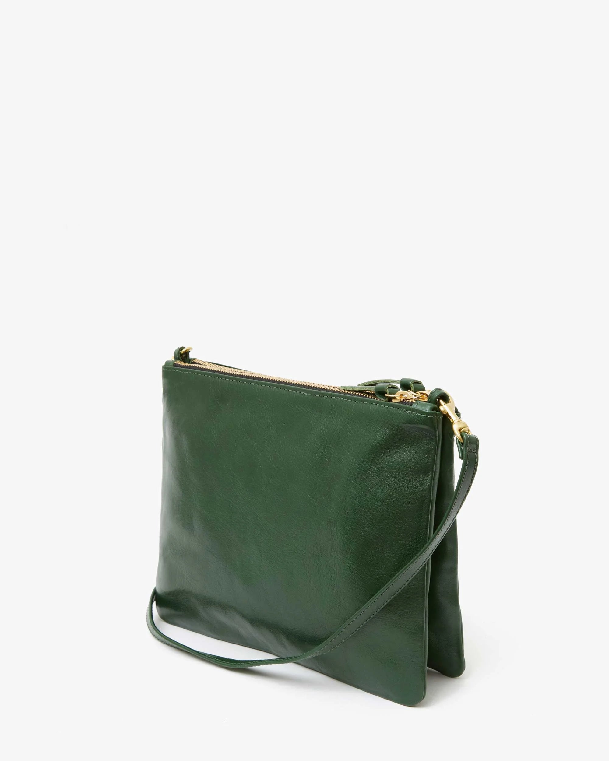 The Double Sac Bretelle by Clare Vivier is an elegant green Italian leather crossbody bag with a sleek and minimalist design. It features gold-tone hardware and a top zip closure, along with double zippered pouches. The detachable, adjustable shoulder strap allows it to be worn as either a crossbody or clutch. Photographed against a plain white background.