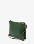 The Double Sac Bretelle by Clare Vivier is an elegant green Italian leather crossbody bag with a sleek and minimalist design. It features gold-tone hardware and a top zip closure, along with double zippered pouches. The detachable, adjustable shoulder strap allows it to be worn as either a crossbody or clutch. Photographed against a plain white background.