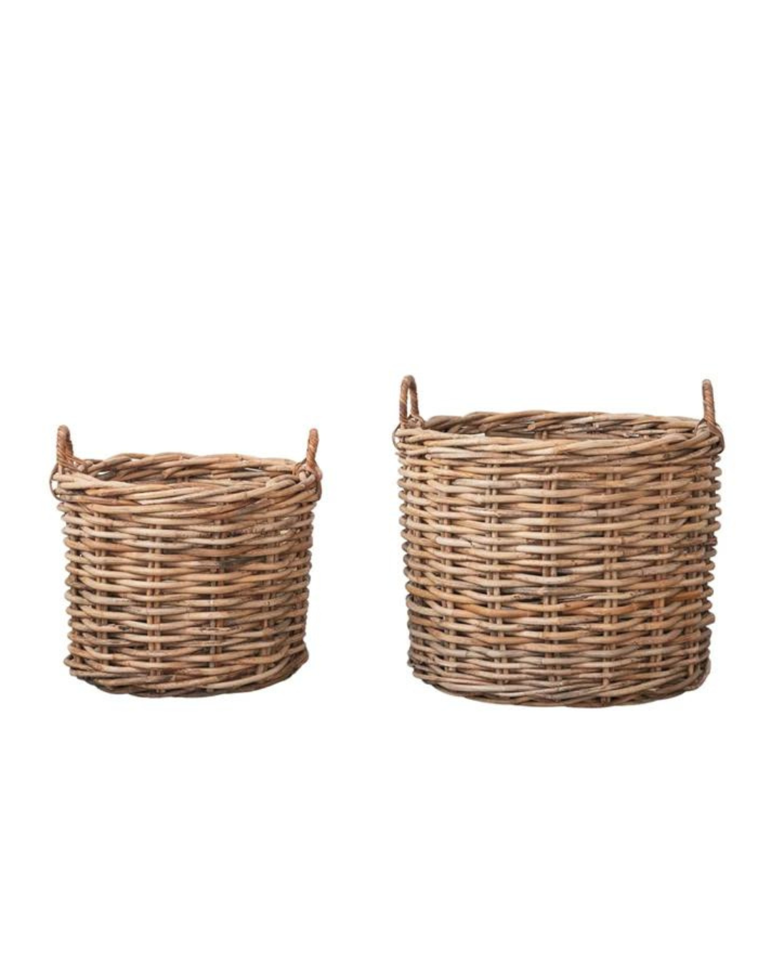 Two Creative Co-op Rattan Baskets with handles are displayed side by side. The smaller one on the left and the larger one on the right both showcase a natural finish. These woven rattan baskets exude rustic charm, with their natural woven material completing the look.