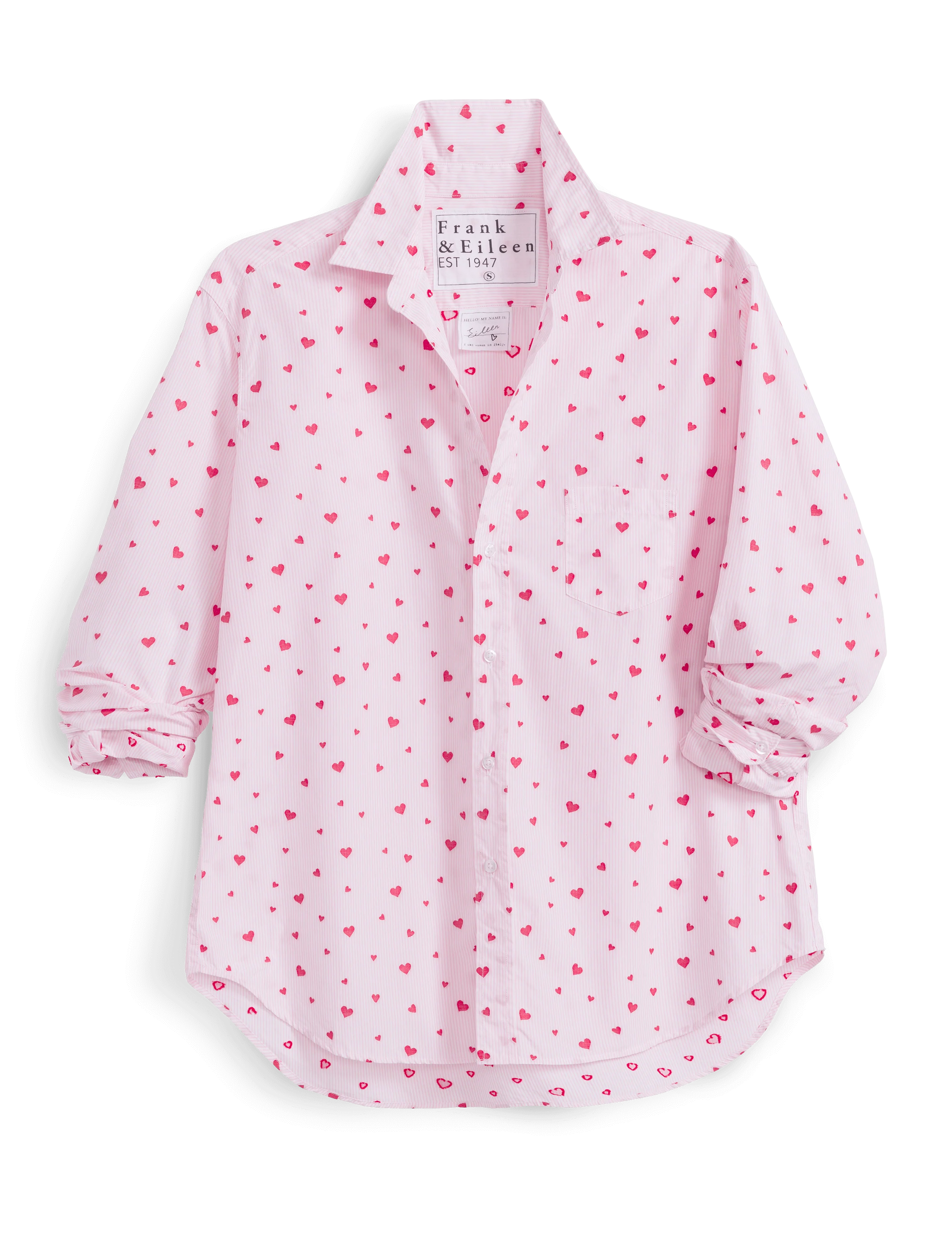 The Frank & Eileen Eileen Tops 2026 is a light pink, 100% cotton long sleeve button-up shirt with small red hearts, a relaxed fit, bust-flattering buttons, rolled sleeves, a collar, and a left chest pocket.