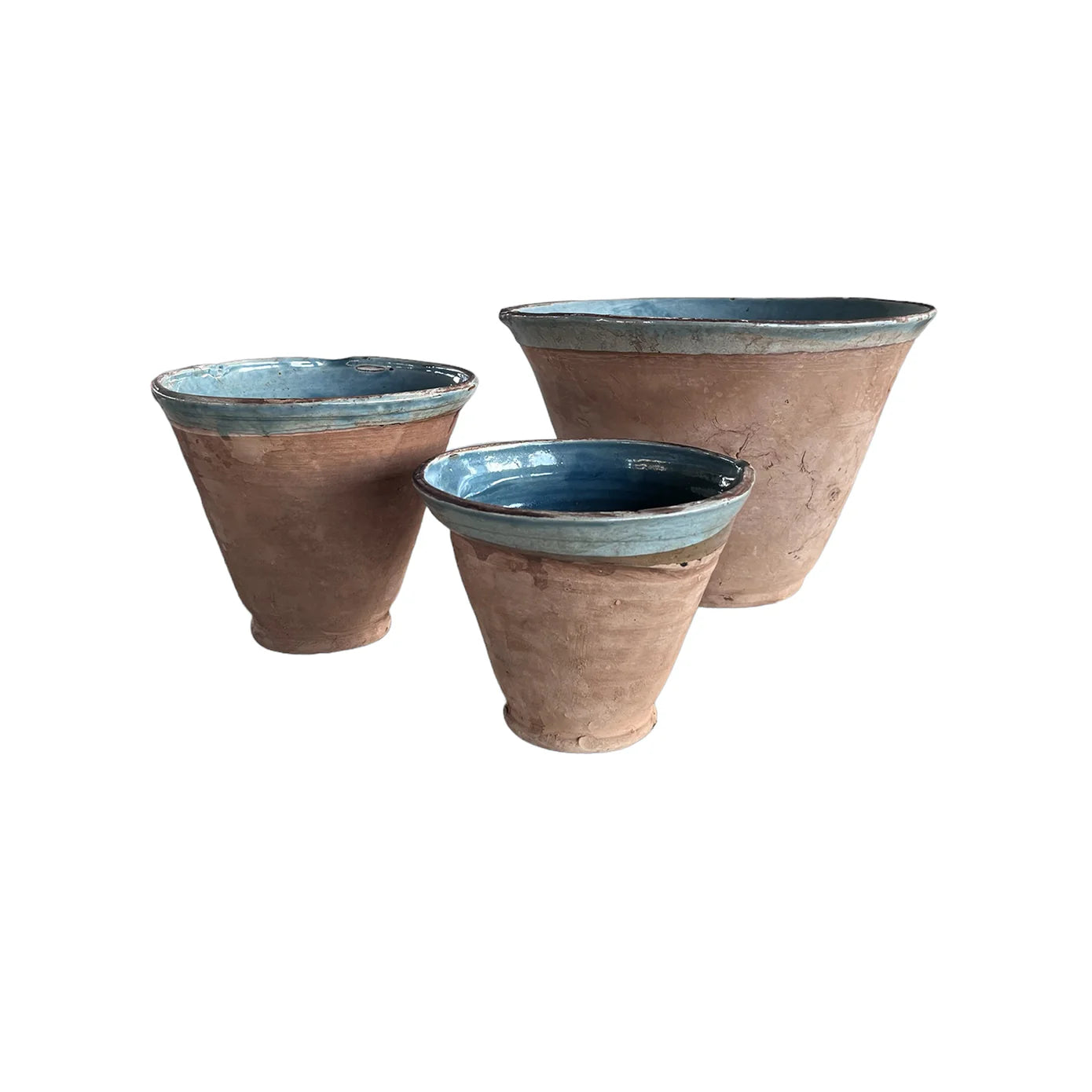 The Blue Ocean Traders Cottage V-Bowl set features three terracotta pots of different sizes with a glossy blue interior and rim, combining handmade pottery charm and elegant design, displayed on a white background.