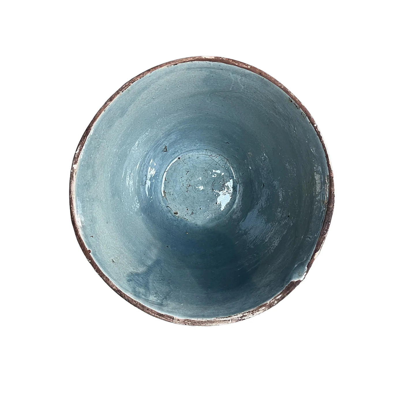 A top view of the Cottage V-Bowl by Blue Ocean Traders, featuring a handmade ceramic design with a blue glazed interior and a rustic, uneven brown rim, set against a white background.