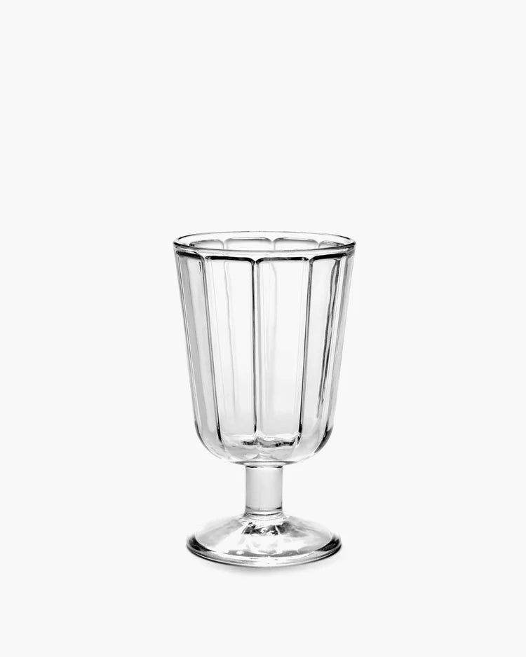 The Serax Surface Glassware is a clear, vintage-style designer goblet with vertical ridges and a short stem, showcased against a plain white background.