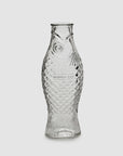 Clear glass fish-shaped carafe with scale and fin details by Serax, upright design, perfect for dining table decor.