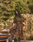 Hunter Bell NYC Eli Top worn outdoors on a wooden dock, creating a relaxed lakeside vibe with natural surroundings.