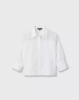 The elly ss shirt by Rag & Bone is a plain white, long-sleeve cropped boxy shirt in cotton poplin, featuring a button front and collar with slightly rolled-up sleeves for a relaxed style, shown on a white background.