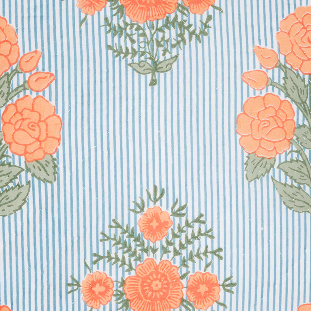 The Bipin Tangerine Quilt by John Robshaw features blue and white vertical stripes with orange floral patterns and green leaves, perfect for coordinating with other patterns or creating eye-catching cotton voile looks.