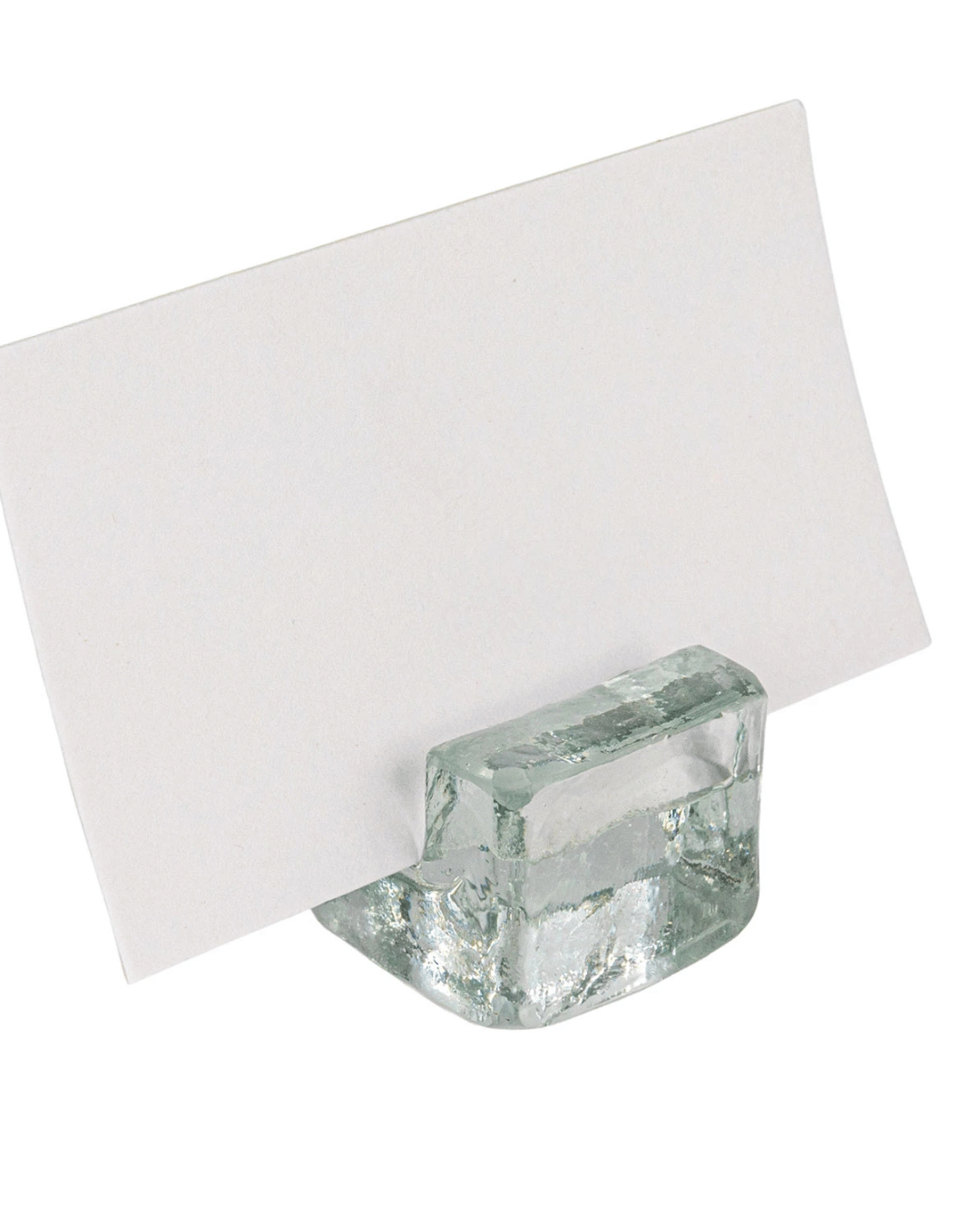 The Creative Co-op Card Holders feature a small, clear glass design that elegantly displays a blank white card. With its rectangular shape, this minimalist piece serves as an ideal place card holder, adding functional elegance to your table decor.