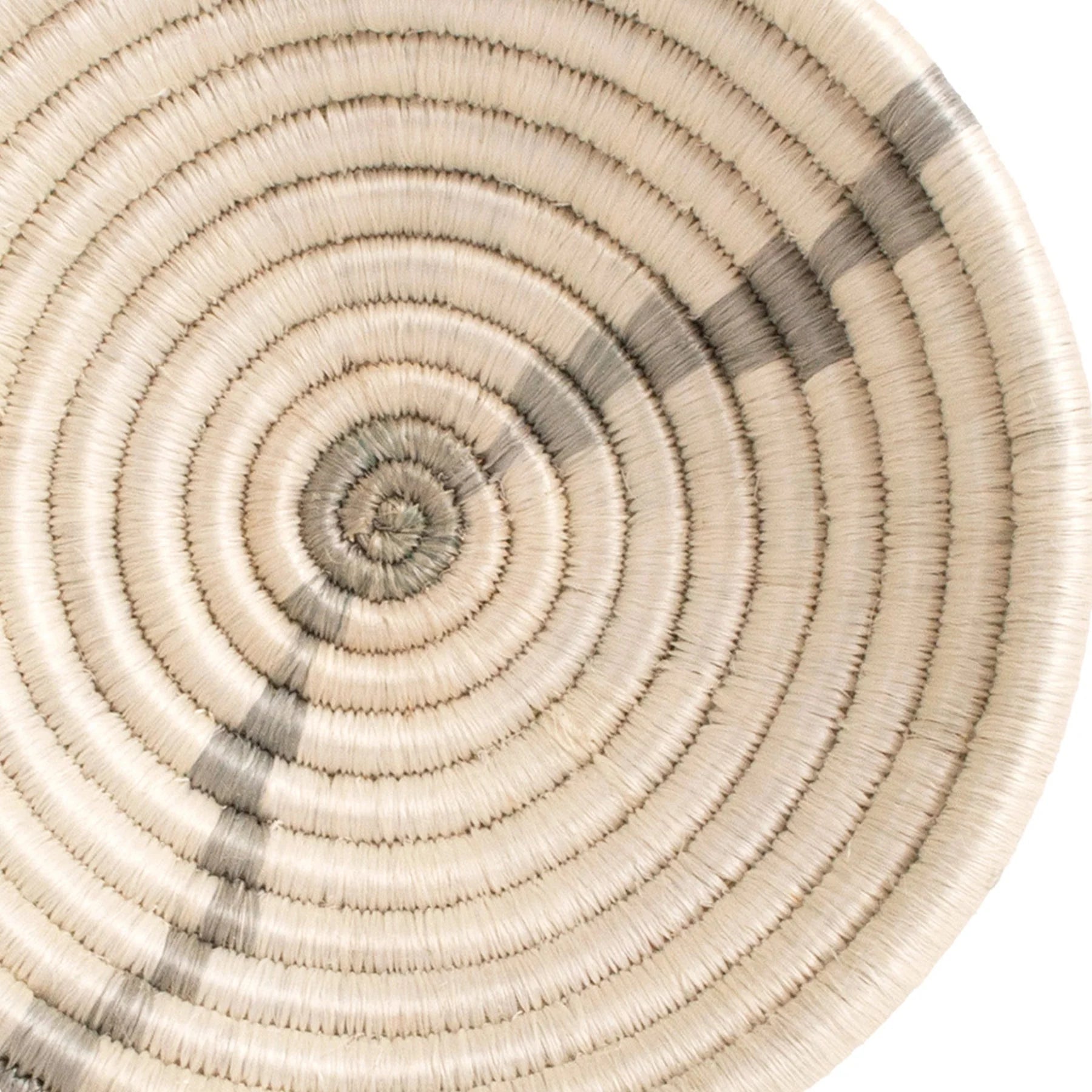 Circular woven bowl featuring a spiral pattern with natural and grey tones, showcasing fine craftsmanship and symmetrical design typical of Scottsdale Arizona bungalow style.