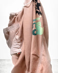 The Loose Drawcord Biggy Pant by Free City (sparrow, LLC) in light pink with graphic print and elastic waistband is displayed against a white background. "freecitysupershop" is shown at the bottom left. Handmade in Los Angeles.