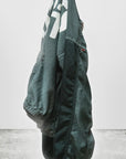 The Artist Wanted Matte Satin Air Jump Shell jogger pants by Free City (sparrow, LLC), handmade in Los Angeles with custom sunfade dye and elastic cuffs, hangs against a plain white background with "freecitysupershop" in black at the bottom left.