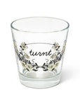 Clear glass tumbler with floral pattern and turnt cursive by Fishes Eddy, made in Italy.
