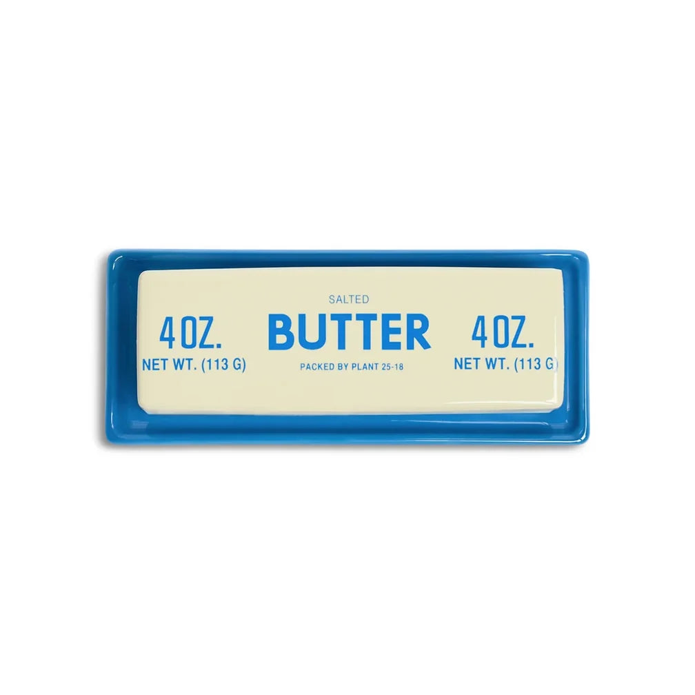 Salted butter stick on Fishes Eddy Butter Stick Dish, blue microwave-safe stoneware tray, kitchen accessory.