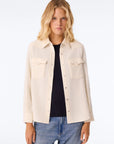 KUJTEN Lumber L/S Shirt layered over a black top and blue jeans, styled simply against a neutral background.