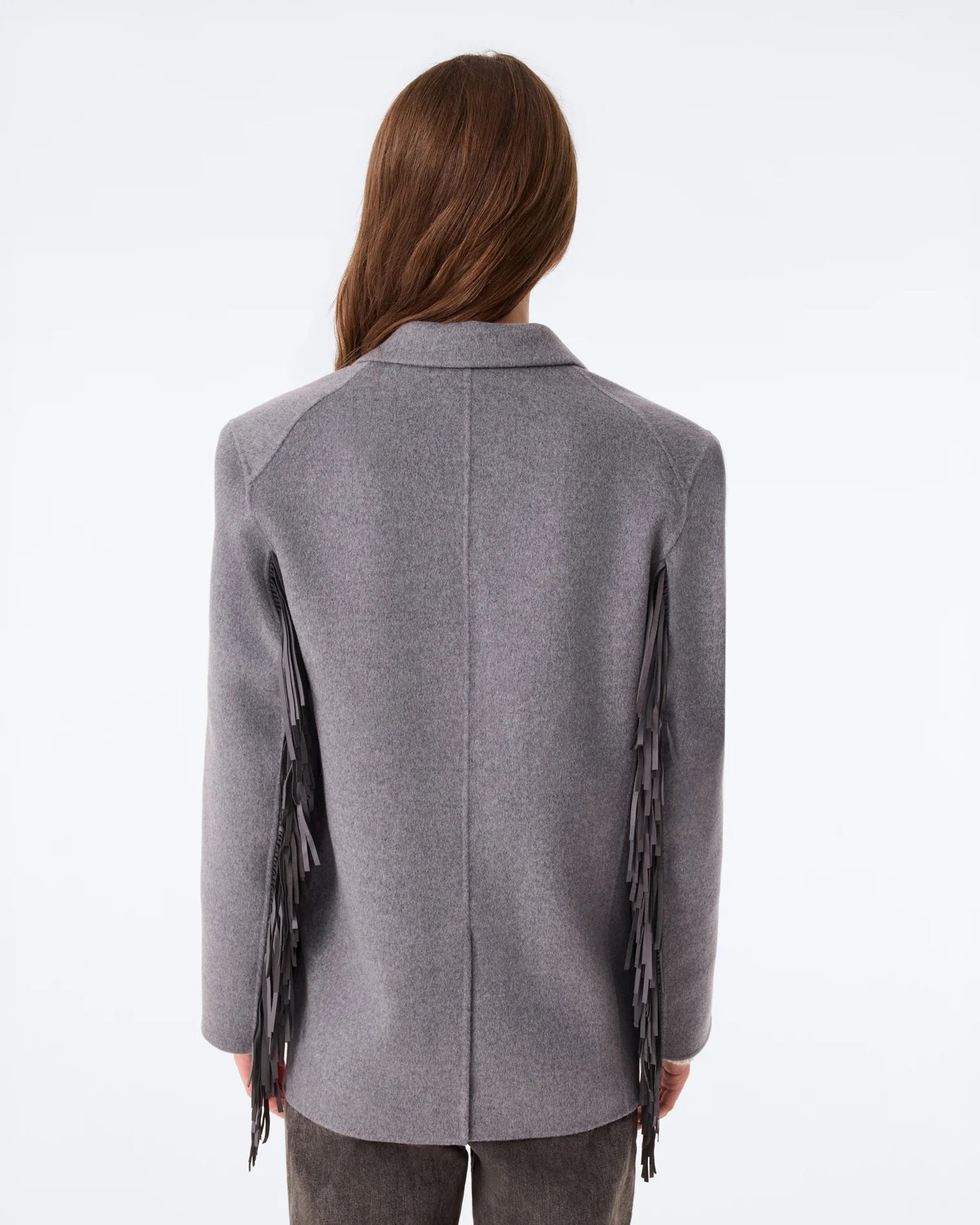 KUJTEN G3 gray flannel blazer with fringe sleeves shown from back, model with straight brown hair.