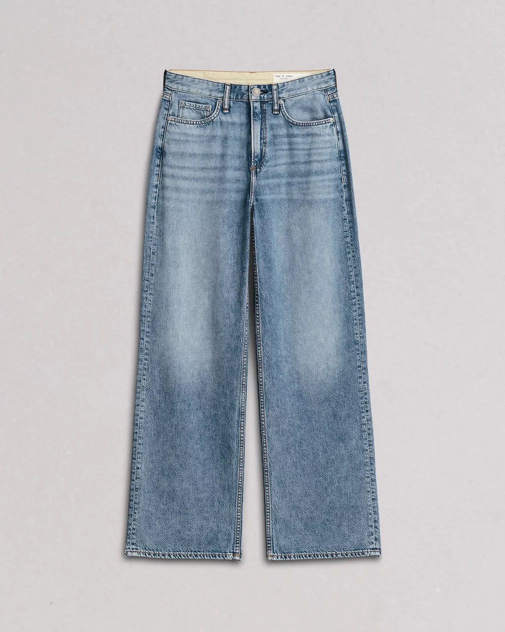The Rag & Bone Logan Pant is a pair of light blue, featherweight denim wide-leg jeans with a high waist, front and back pockets, and a faded wash, shown flat on a plain light background.