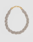 The Fete Collar by Clare Vivier is a braided necklace with rows of sparkling pavé glass stones and a vintage gold-plated brass foldover clasp, shown on a plain white background.