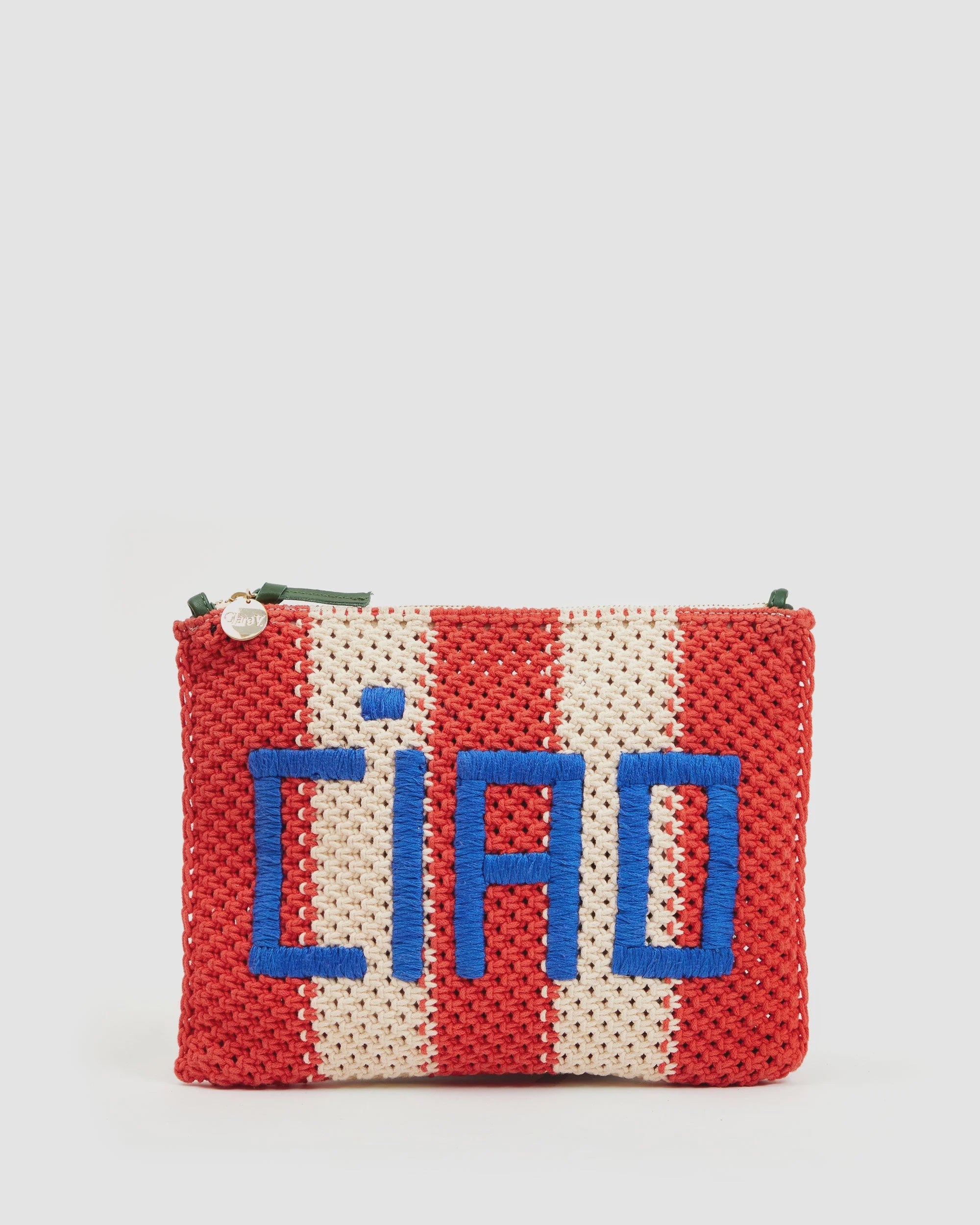 The Clare Vivier Flat Clutch W/ Tabs S25 is a crocheted cotton pouch with red and white stripes and bold blue "CIAO" lettering, featuring a top zipper—perfect for organizing your essentials in style.