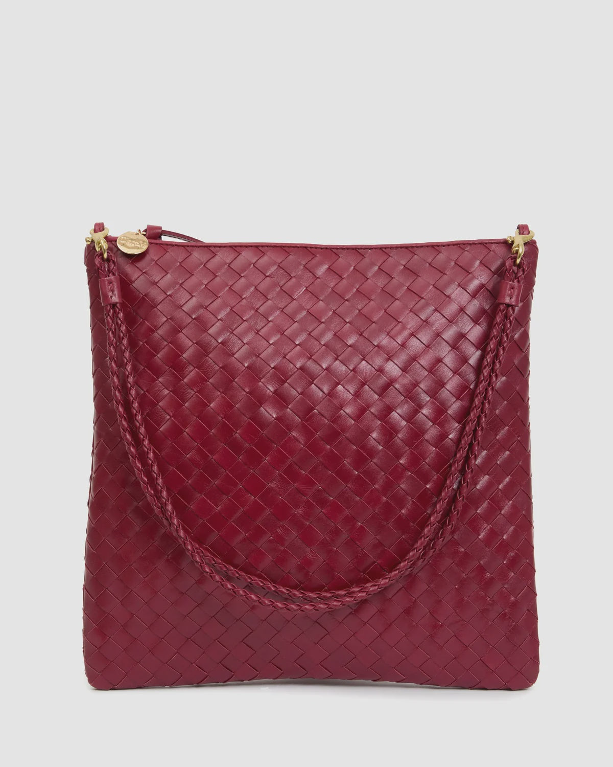 Maroon handwoven leather foldover clutch with braided handle and gold zipper by Clare Vivier.
