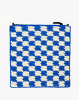 A crocheted cotton bag featuring a checkered pattern with alternating blue and white squares. The Foldover Clutch w/Tabs by Clare Vivier has dark handles at the top.