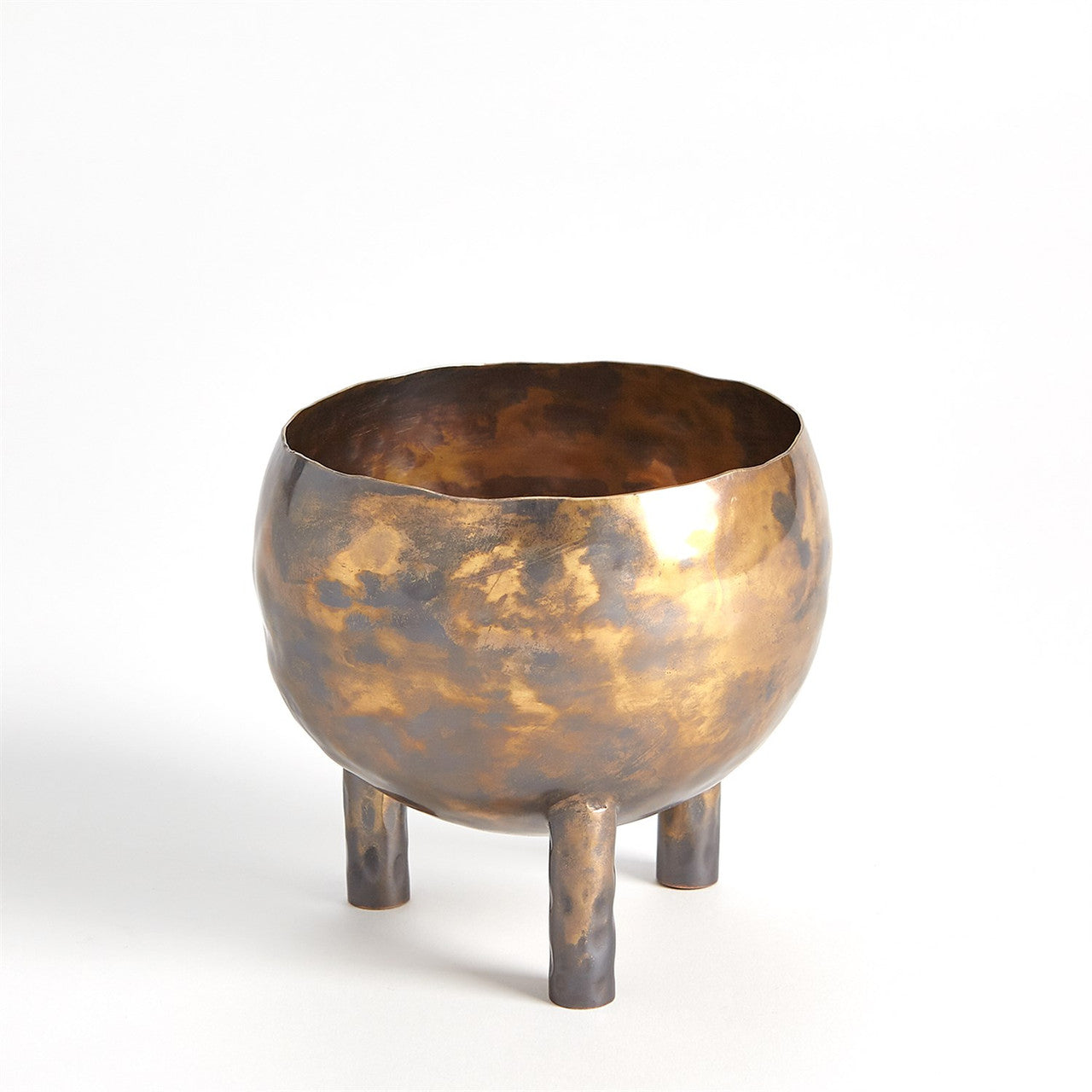 The Alchemy Container Burnt Brass S by Global Views is a round, hammered metallic vessel in golden-bronze, standing on three cylindrical legs against a plain white background.