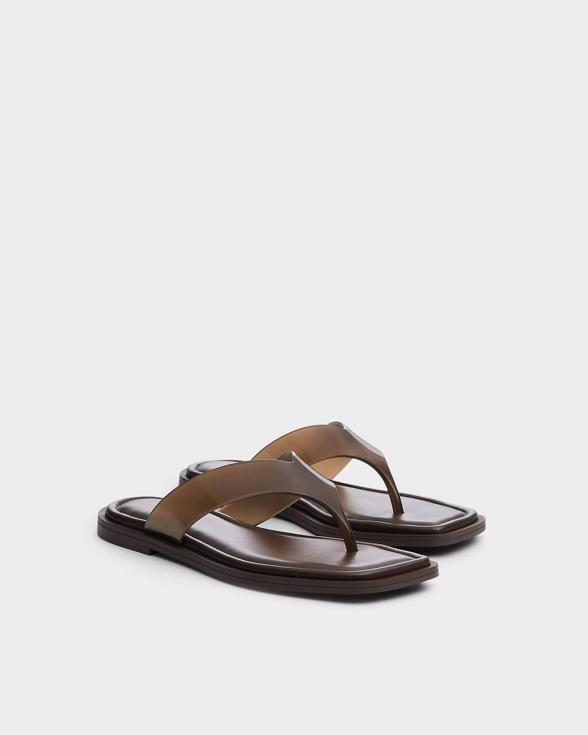 The Rag &amp; Bone gracie jelly thong sandals in brown feature wide straps, a geometric square toe, and comfy OrthoLite foam insoles, shown against a plain white background.