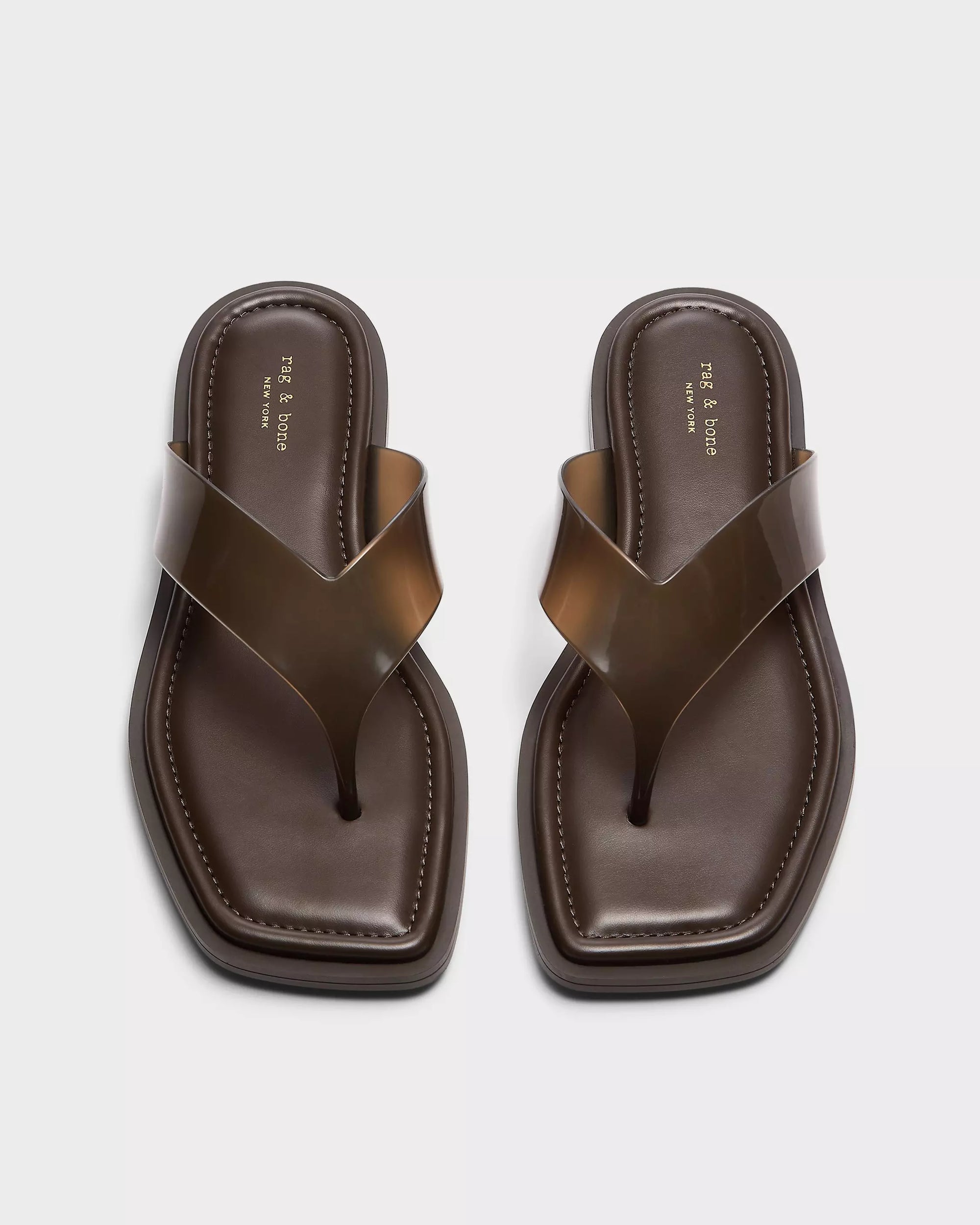 A pair of Rag &amp; Bone gracie jelly thong sandals with brown, geometric square toes, glossy wide straps, and cushioned footbeds, shown side by side on a light background.